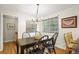 Inviting dining room with hardwood floors, a modern chandelier, and a window at 6235 E 6Th Avenue Pkwy, Denver, CO 80220
