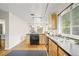 Galley kitchen featuring stainless steel sink, track lighting, and hardwood floors at 6235 E 6Th Avenue Pkwy, Denver, CO 80220