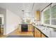 Spacious kitchen with wood cabinets, black countertops, and stainless-steel appliances at 6235 E 6Th Avenue Pkwy, Denver, CO 80220
