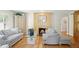Bright living room with wood floors, stylish seating, and a modern fireplace focal point at 6235 E 6Th Avenue Pkwy, Denver, CO 80220