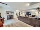 Spacious basement area featuring a large couch, television and entertainment center at 9751 Mobile St, Commerce City, CO 80022