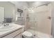 Bathroom with white vanity and tiled shower and modern glass door at 9751 Mobile St, Commerce City, CO 80022