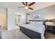 Bedroom featuring a ceiling fan, large window, and en-suite bathroom at 9751 Mobile St, Commerce City, CO 80022
