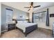 Comfortable bedroom featuring a ceiling fan, large window, and neutral carpet at 9751 Mobile St, Commerce City, CO 80022