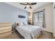Inviting bedroom featuring a queen-sized bed, a window, and soft gray walls at 9751 Mobile St, Commerce City, CO 80022