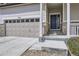 Close up view of a home's entrance featuring a two car garage and covered porch at 9751 Mobile St, Commerce City, CO 80022