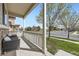 Relaxing covered porch with seating overlooking a serene street and a lush green lawn at 9751 Mobile St, Commerce City, CO 80022