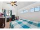 Bright bedroom with a ceiling fan, a desk by the window, and a comfortable bed at 1845 Kendall St # 325D, Denver, CO 80214