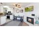 Inviting dining area features a fireplace and modern ceiling fan at 1845 Kendall St # 325D, Denver, CO 80214