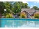 Inviting pool area with lush greenery and a glimpse of the charming home beyond the pool fence at 1845 Kendall St # 325D, Denver, CO 80214