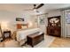 Bedroom with hardwood floors, large windows, and neutral decor at 12920 W 24Th Pl, Golden, CO 80401