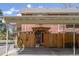 View of carport with privacy fencing and brick house in background at 12920 W 24Th Pl, Golden, CO 80401
