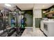 Home gym with weight training equipment, laundry facilities, and dark green walls at 12920 W 24Th Pl, Golden, CO 80401
