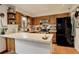 Open kitchen with a breakfast bar, oak cabinets, and stainless steel appliances at 12920 W 24Th Pl, Golden, CO 80401