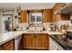 Kitchen with wood cabinets, white countertops, double sink, and stainless steel appliances at 12920 W 24Th Pl, Golden, CO 80401