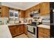 Kitchen featuring wood cabinets, white countertops, and stainless steel oven at 12920 W 24Th Pl, Golden, CO 80401