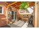 Cozy covered patio with brick accents, potted plants, and string lights at 12920 W 24Th Pl, Golden, CO 80401