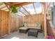 Enclosed patio with comfortable outdoor seating, covered top, and privacy fence at 12920 W 24Th Pl, Golden, CO 80401