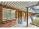 Private apartment entrance with brick facade, covered walkway, and outdoor access at 155 S Pennsylvania St # 101, Denver, CO 80209