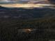 Luxury home nestled in the mountains at sunset, city views at 26271 Richmond Hill Rd, Conifer, CO 80433