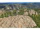 Aerial view of rugged terrain, showcasing rocky landscape and lush greenery at 26271 Richmond Hill Rd, Conifer, CO 80433