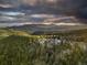 Mountaintop home with expansive views of the surrounding landscape at 26271 Richmond Hill Rd, Conifer, CO 80433