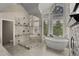 Luxurious bathroom with a walk-in shower, soaking tub and expansive windows at 26271 Richmond Hill Rd, Conifer, CO 80433