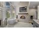 Spa-like bathroom with a freestanding tub, fireplace, and large shower at 26271 Richmond Hill Rd, Conifer, CO 80433