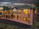 Brick home with large windows, a deck, and beautiful landscaping at 26271 Richmond Hill Rd, Conifer, CO 80433
