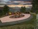 Brick house with a large circular driveway and mountain views at sunset at 26271 Richmond Hill Rd, Conifer, CO 80433