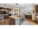 Open concept kitchen boasts a large island with cooktop and ample cabinet space at 26271 Richmond Hill Rd, Conifer, CO 80433