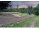 Newly cleared land with a tractor, creating space for a new structure at 26271 Richmond Hill Rd, Conifer, CO 80433