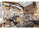 Spacious living room with a large brick fireplace and high ceilings at 26271 Richmond Hill Rd, Conifer, CO 80433