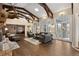 Spacious living room features high ceilings, hardwood floors, and a cozy fireplace at 26271 Richmond Hill Rd, Conifer, CO 80433