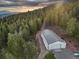 Large metal shop with three garage doors at 26271 Richmond Hill Rd, Conifer, CO 80433