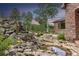 Landscaped water feature with stone accents and greenery at 26271 Richmond Hill Rd, Conifer, CO 80433