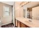 Bathroom featuring a large mirror, vanity with sink, and a shower with a curtain at 3532 Morning Glory Dr, Castle Rock, CO 80109