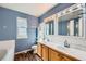 A double vanity and a large mirror add style to this traditional blue bathroom at 3532 Morning Glory Dr, Castle Rock, CO 80109