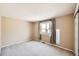 Bright bedroom featuring neutral walls, plush carpet, and a window with light-filtering curtains at 3532 Morning Glory Dr, Castle Rock, CO 80109