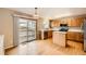 Bright kitchen with stainless steel appliances, light wood cabinets, a center island, and sliding glass doors at 3532 Morning Glory Dr, Castle Rock, CO 80109