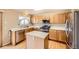 Well-lit kitchen featuring stainless steel appliances, light wood cabinets, and a center island at 3532 Morning Glory Dr, Castle Rock, CO 80109
