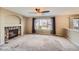 Spacious living room with a stone fireplace, ceiling fan, large window, and neutral colored walls at 3532 Morning Glory Dr, Castle Rock, CO 80109
