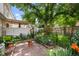 Inviting backyard with brick patio, lush landscaping, and a charming pergola at 272 S 22Nd Ave, Brighton, CO 80601
