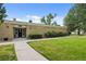 Well-maintained building exterior with a walkway and green lawn, creating a welcoming approach at 272 S 22Nd Ave, Brighton, CO 80601