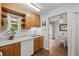 Charming kitchen with wooden cabinets, stainless steel sink, and a view into the adjacent dining area at 272 S 22Nd Ave, Brighton, CO 80601