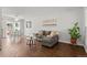 Cozy living room featuring hardwood floors and a comfortable gray sofa with yellow pillows at 272 S 22Nd Ave, Brighton, CO 80601