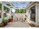 This peaceful patio space features an overhead trellis, seating, and charming potted plants at 272 S 22Nd Ave, Brighton, CO 80601