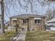 Ranch style home with stone exterior, walkway, and mature trees at 1333 Hanover St, Aurora, CO 80010