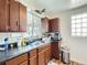 Bright kitchen features dark wood cabinets and a double sink at 1333 Hanover St, Aurora, CO 80010