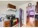 Kitchen with wood cabinets, appliances, and tiled backsplash at 1333 Hanover St, Aurora, CO 80010